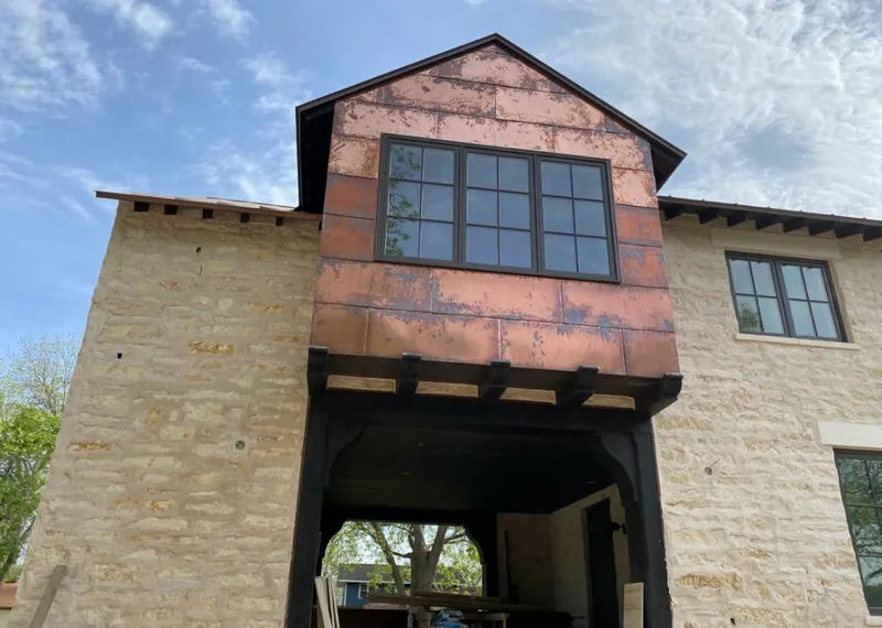 Copper metal panel facade on a stone building for Skylight Installation in Chalco